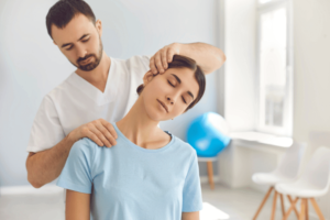 A Chiropractor Doing Neck Adjustment to Female Patient in Modern Clinic