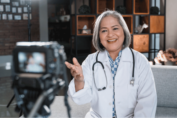A Female Doctor Recording a Video Using a Professional Camera