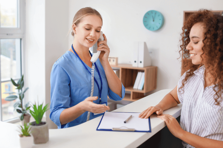 Young Female Receptionist Working with Patient in Clinic